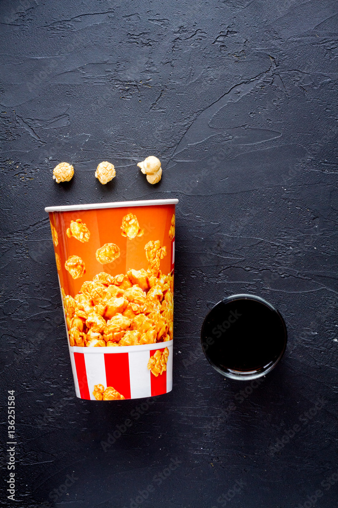 concept of watching movies with popcorn top view dark background