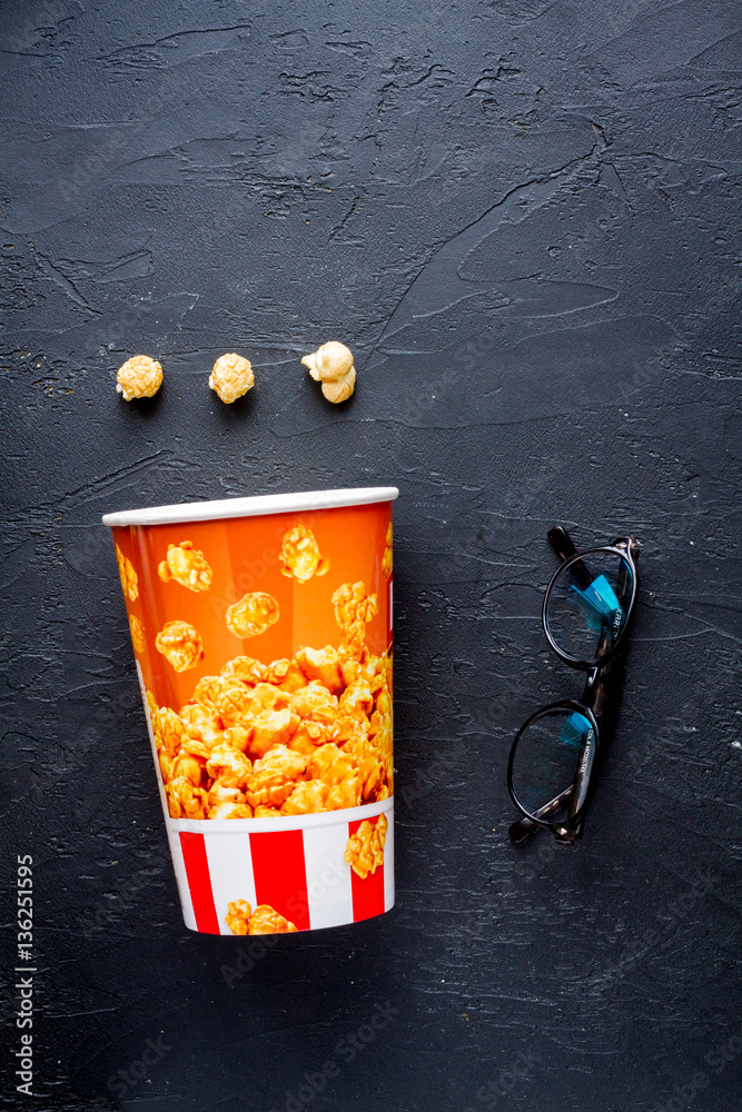 concept of watching movies with popcorn top view dark background