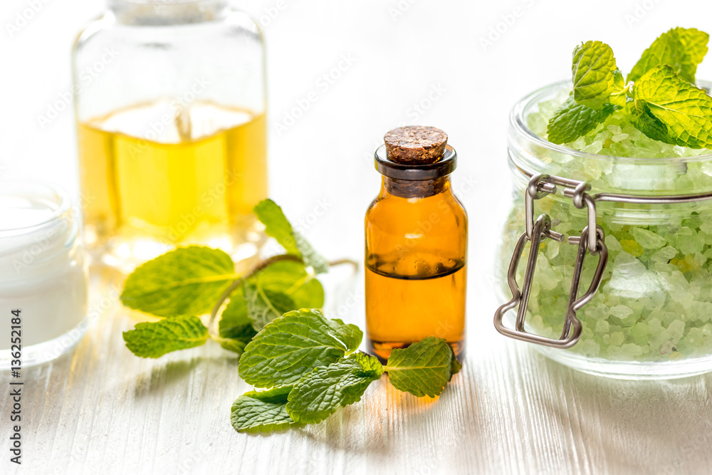 organic cosmetics with herbal extracts of mint on wooden background