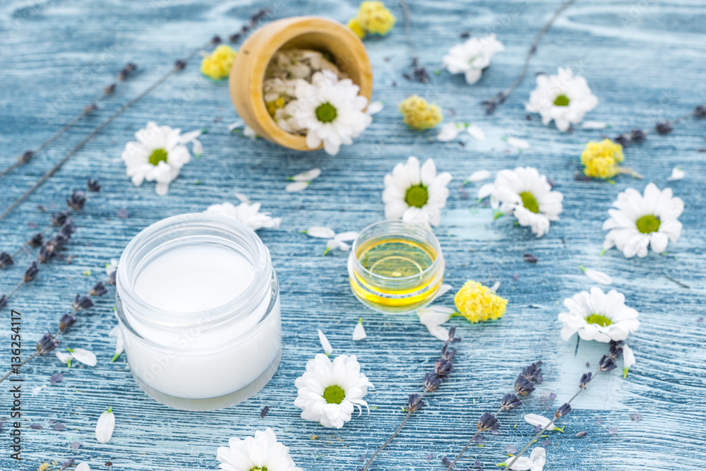 organic cosmetics with camomile on blue background