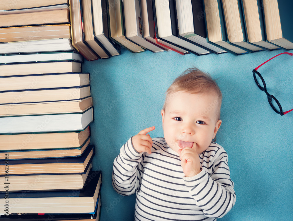 One year old baby with spectackles and books