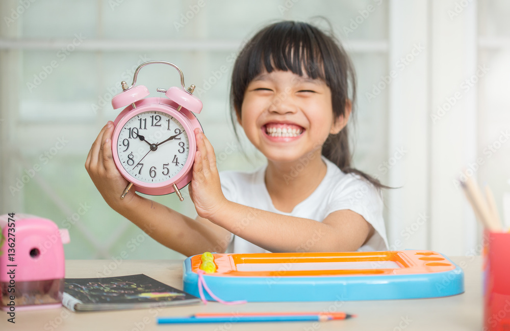 childhood and education concept - happy student girl preparing for school exams