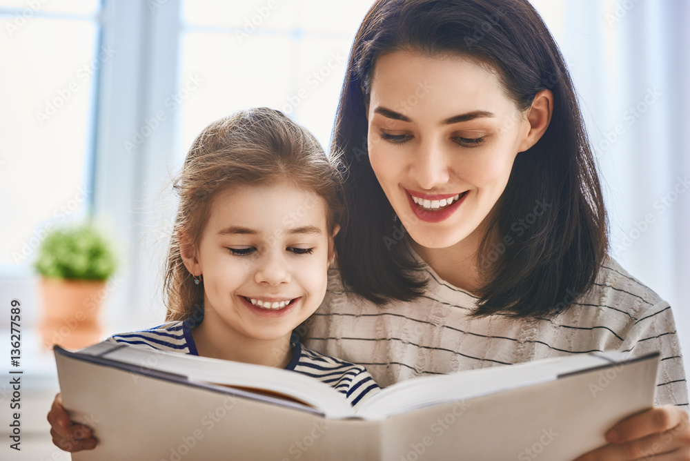 mother and daughter reading a book