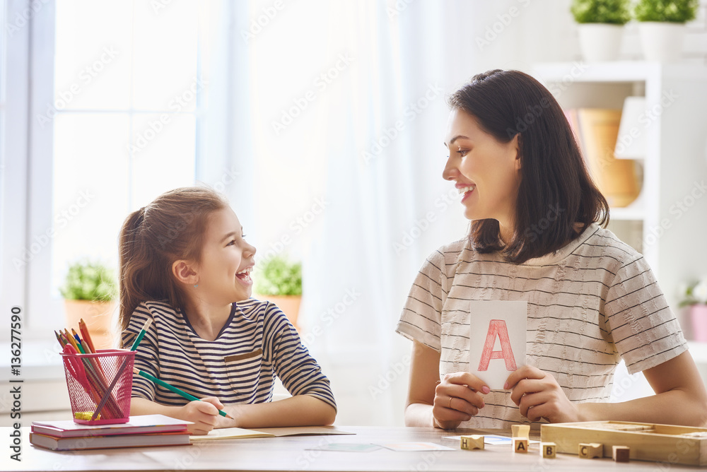 woman teaches child the alphabet