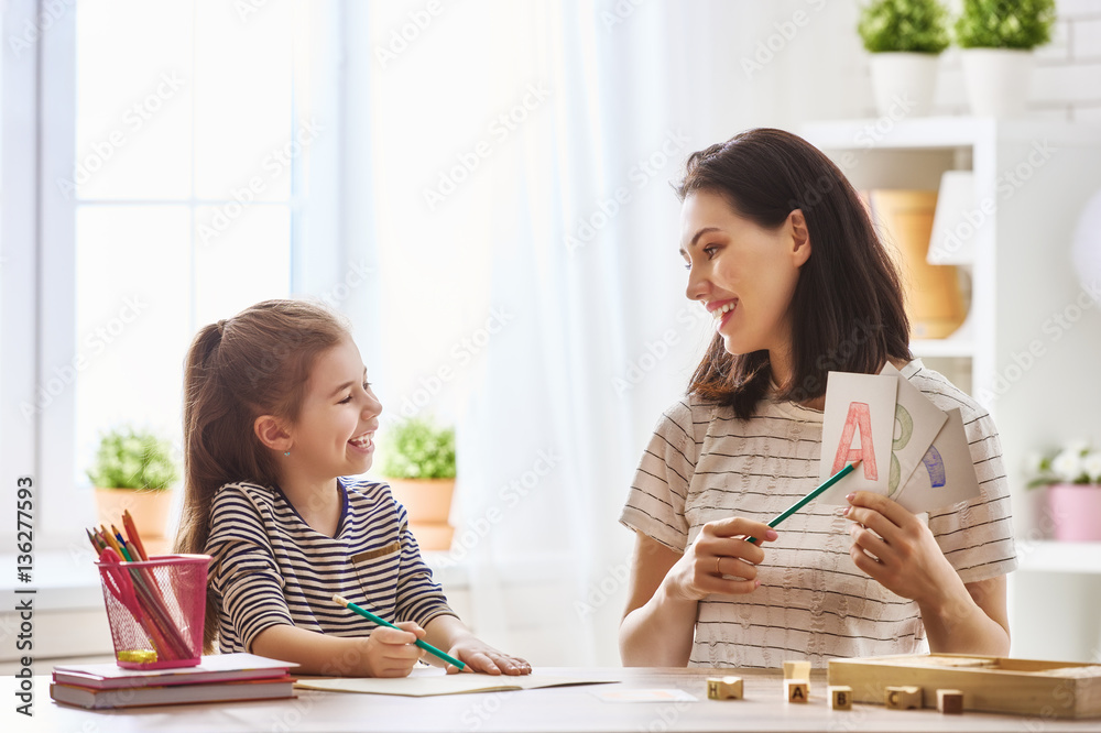 woman teaches child the alphabet