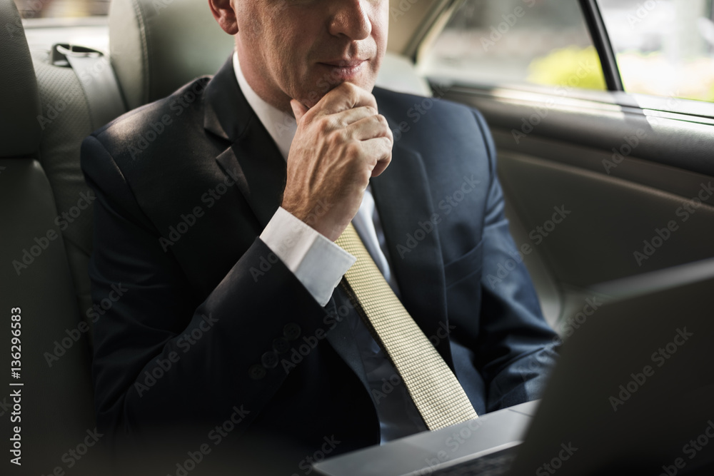 Businessman Using Laptop Car Inside