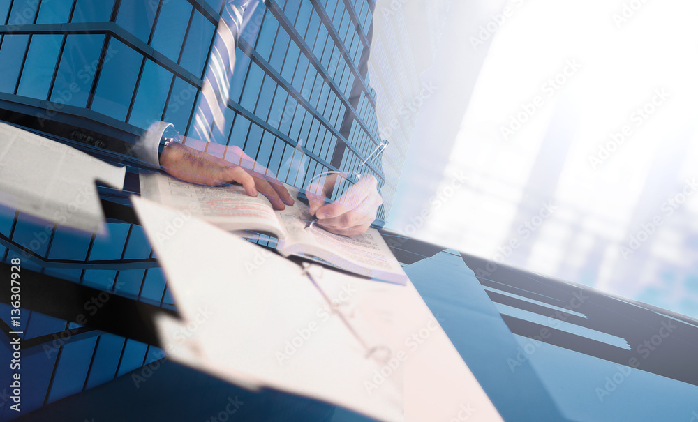 Businessman studying in his office. Double exposure