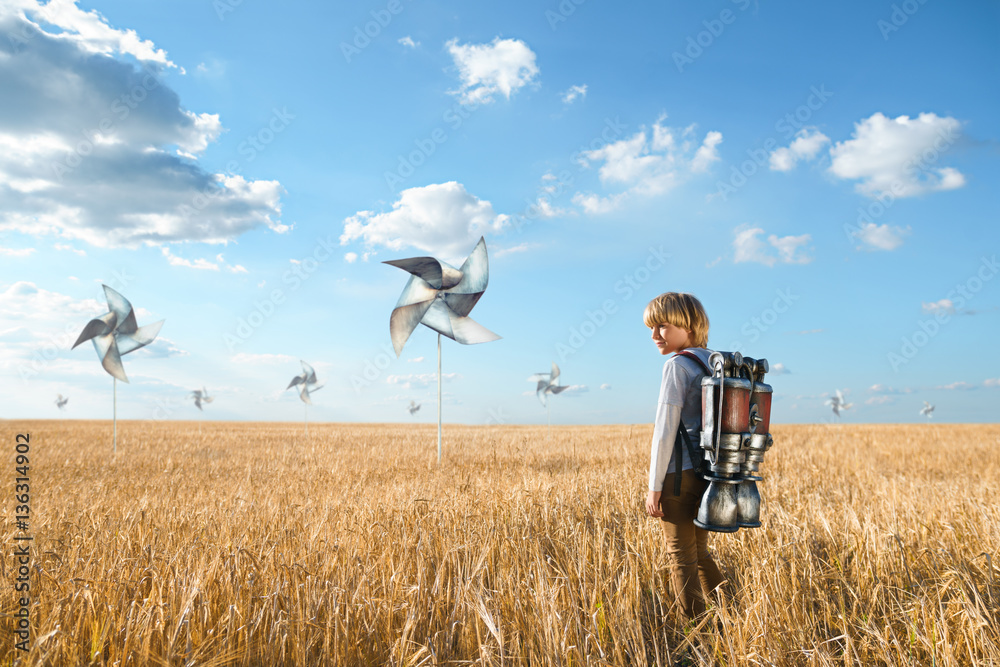 Boy in a field with propellers