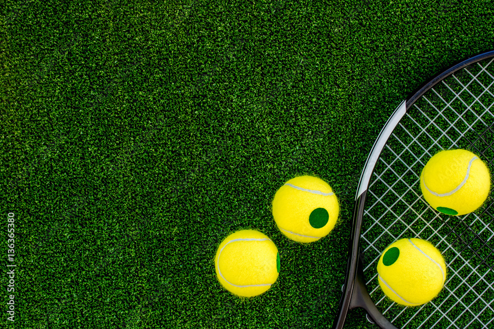 tennis racket on green background top view