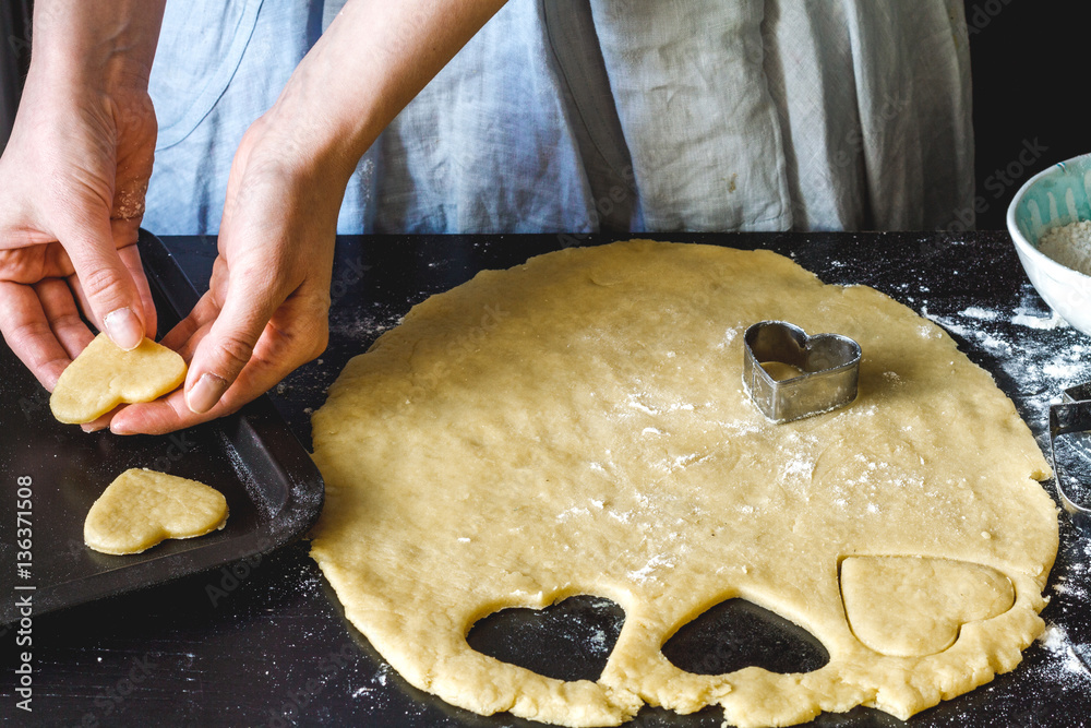 cooking homemade cookies with hands on dark background