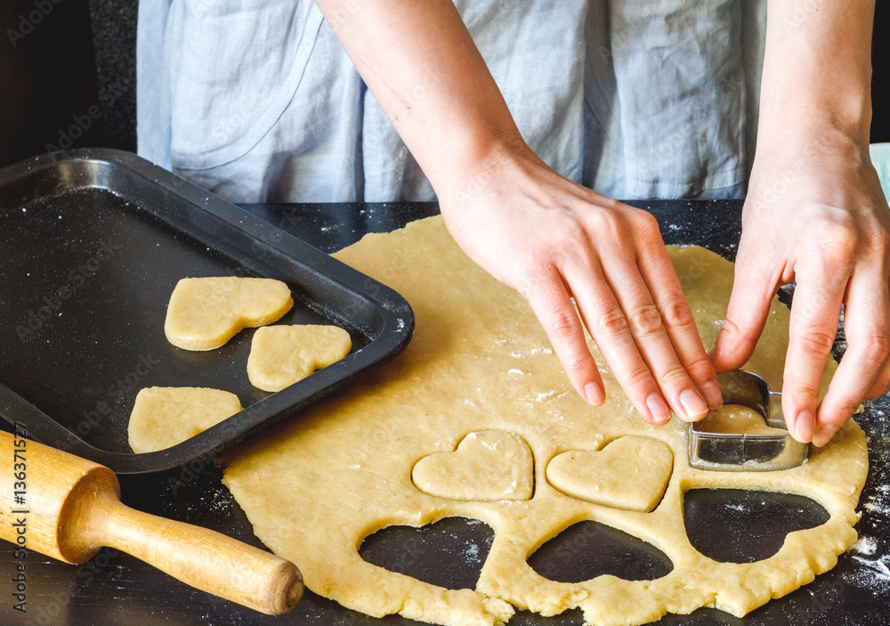 cooking homemade cookies with hands on dark background