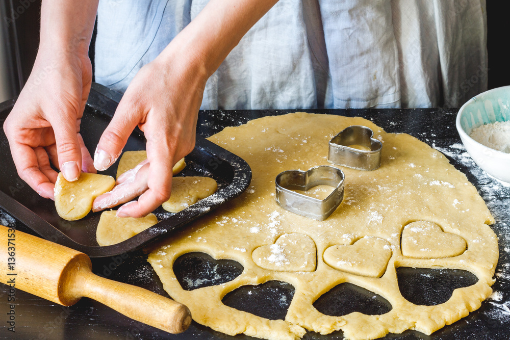 cooking homemade cookies with hands on dark background