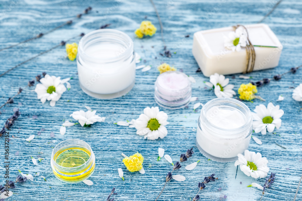 organic cosmetics with camomile on blue background