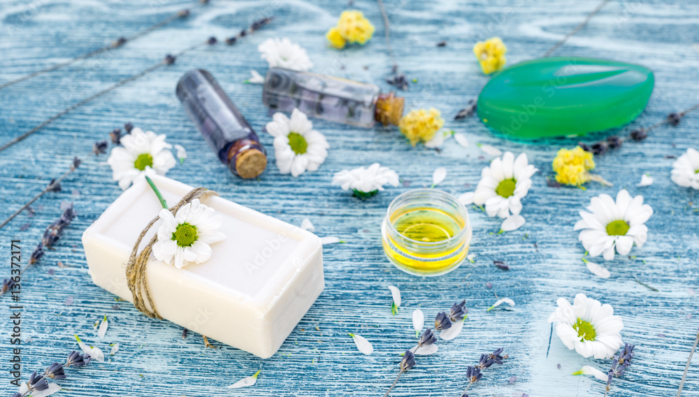 organic cosmetics with camomile on blue background