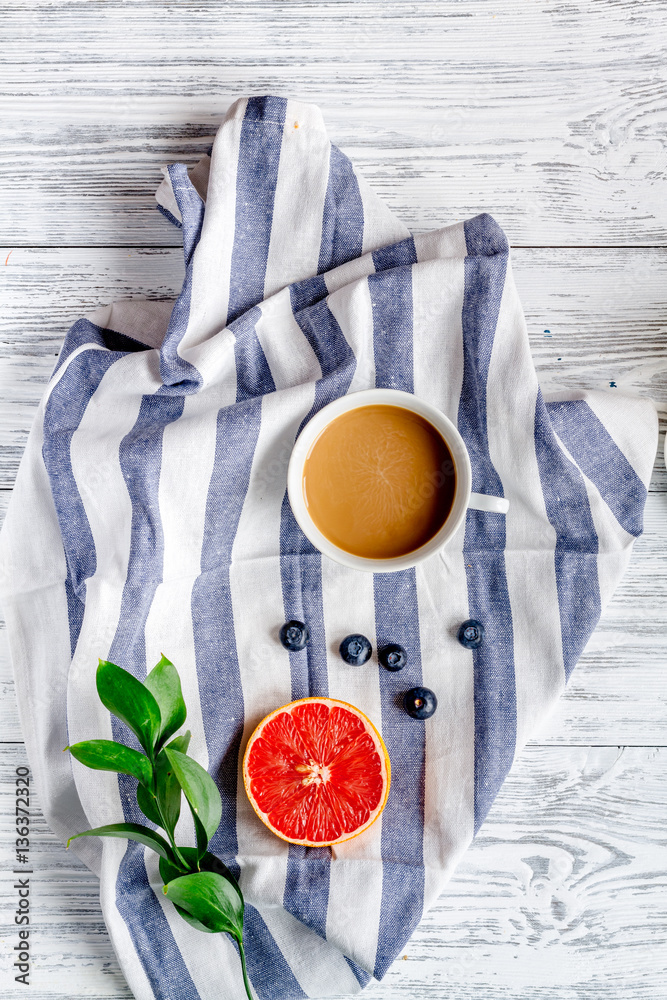 Breakfast concept with flowers on wooden background top view