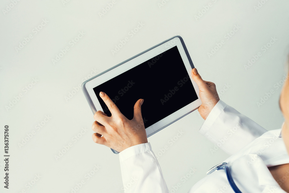 Close of female doctor hands working with tablet pc computer