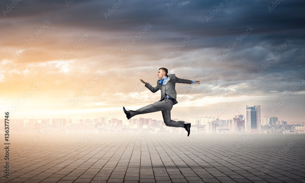 Businessman jumping high