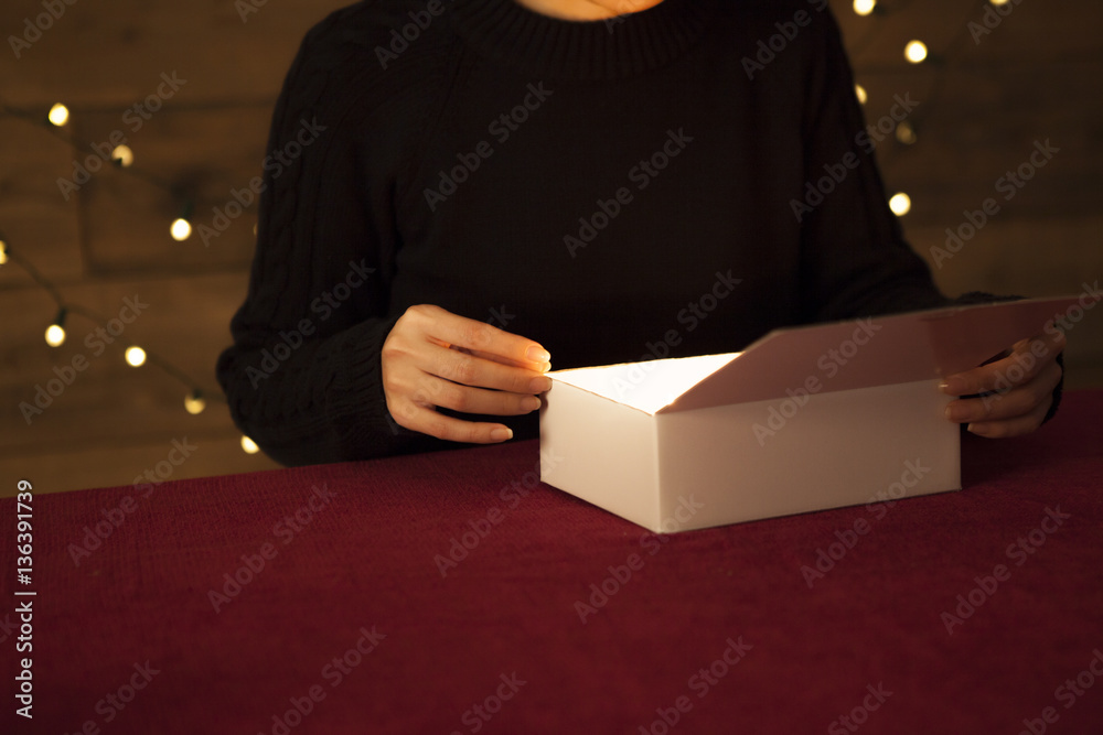 The woman is surprised to see inside the present box