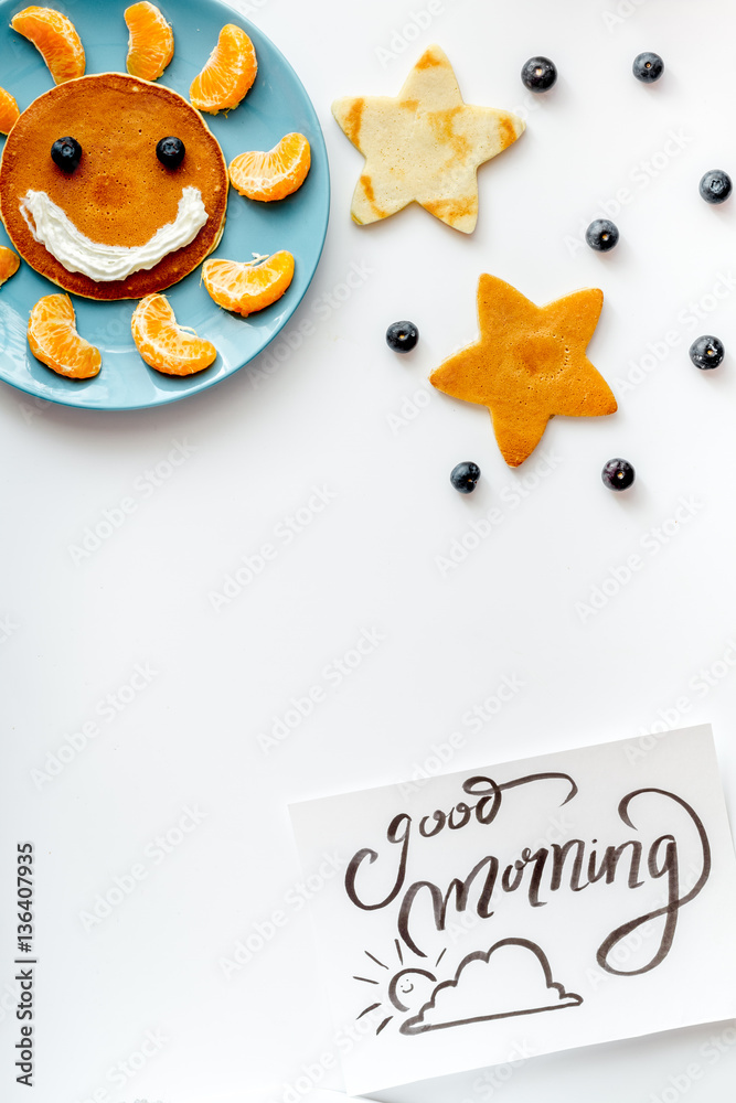 concept kid breakfast with pancake top view on white background