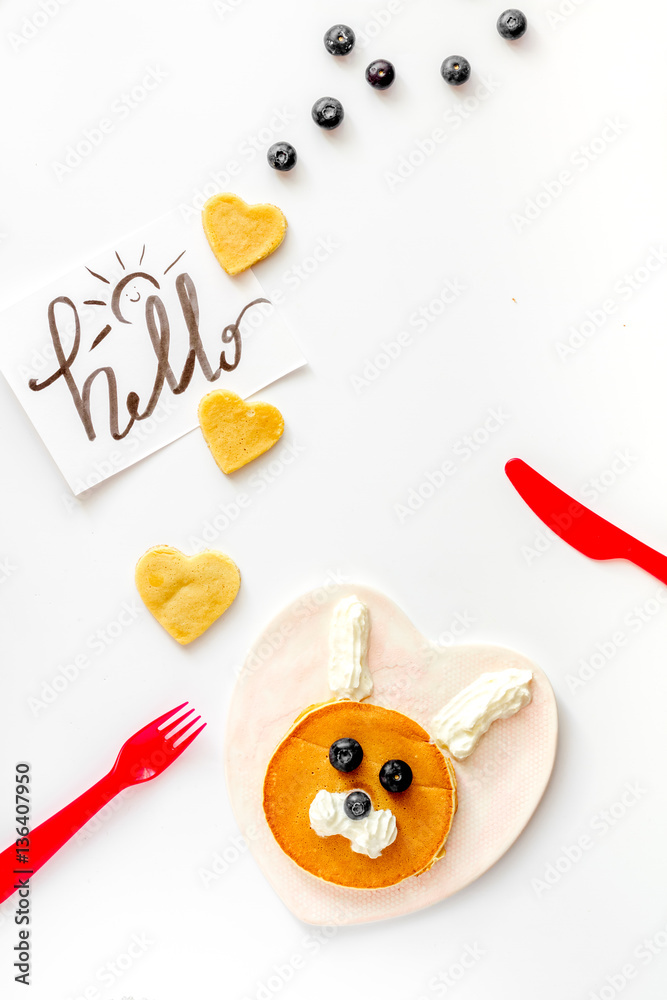 concept kid breakfast with pancake top view on white background