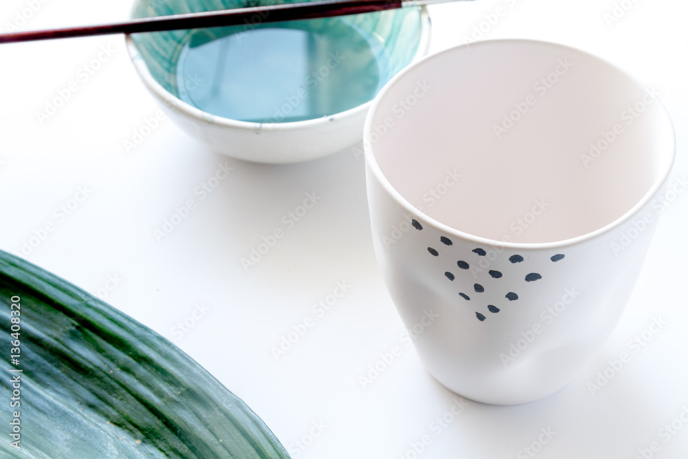 painted ceramic cup on white background