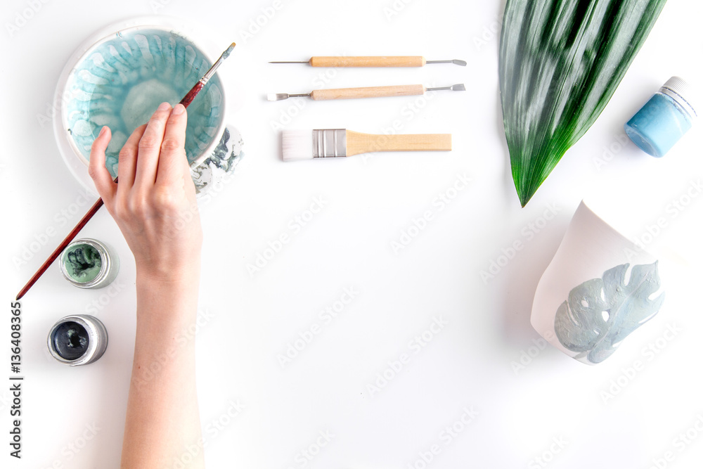 painted ceramic cup on white background top view