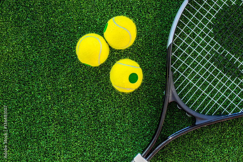 tennis racket on green background top view