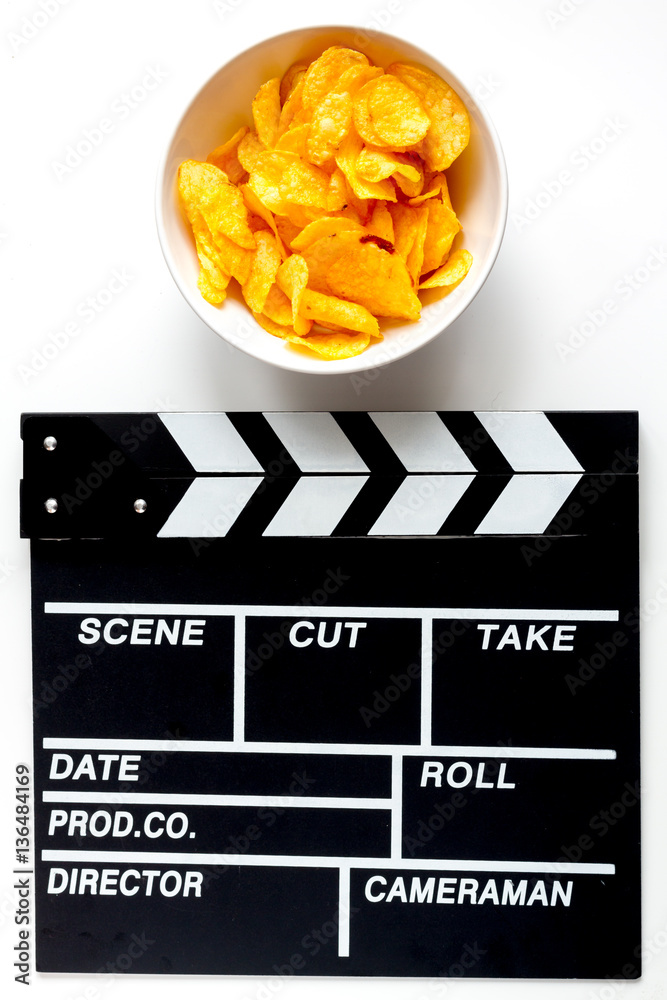 Screenwriter desktop with movie clapper board white background top view