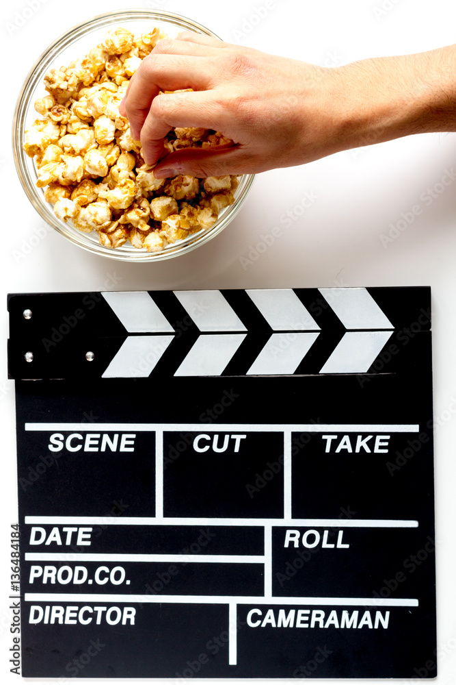 Screenwriter desktop with movie clapper board white background top view