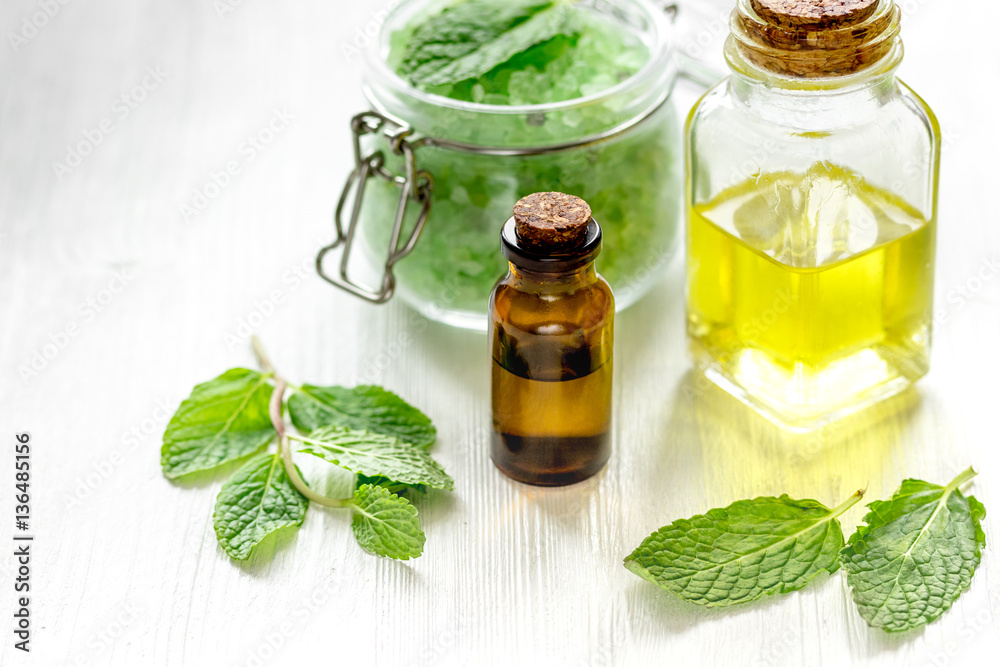 organic cosmetics with herbal extracts of mint on wooden background