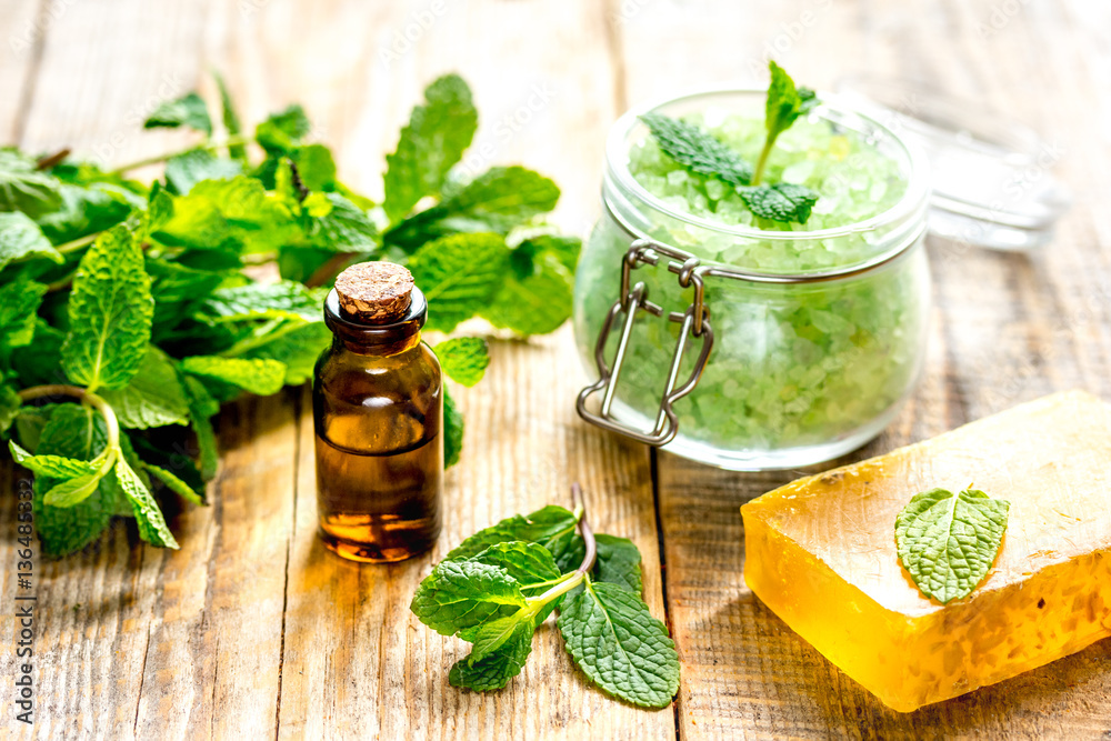 organic cosmetics with herbal extracts of mint on wooden background