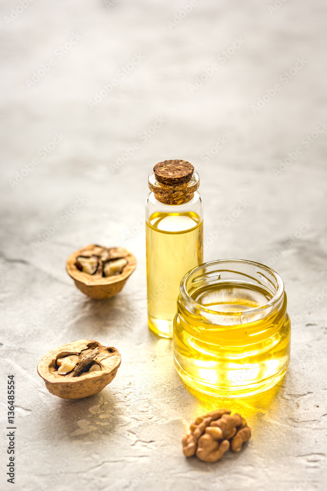 cosmetic and therapeutic walnut oil on gray background