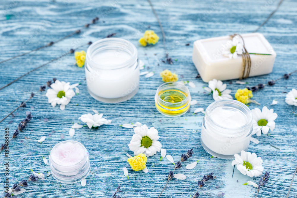 organic cosmetics with camomile on blue background