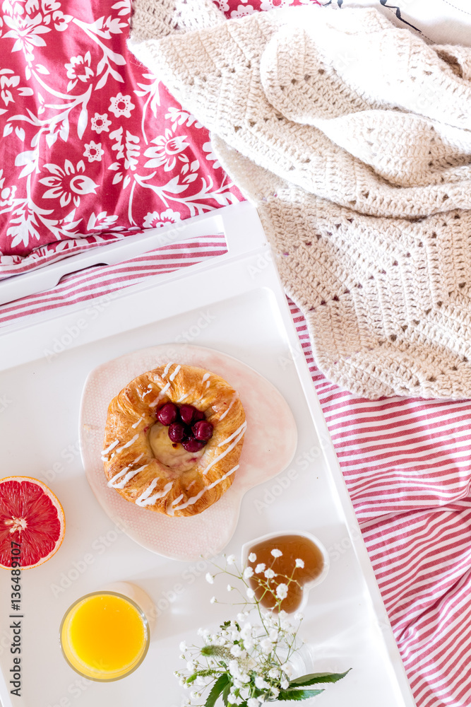 concept of breakfast in bed on tray with juice