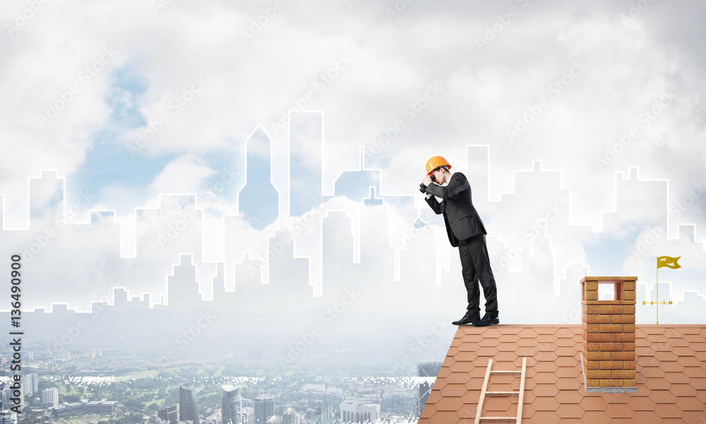 Engineer man standing on roof and looking in binoculars. Mixed media