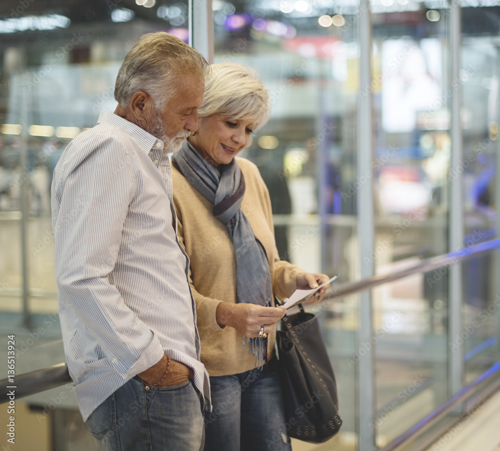 Senior couple traveling airport scene