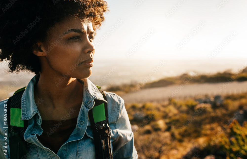 Young african female hiker standing in nature