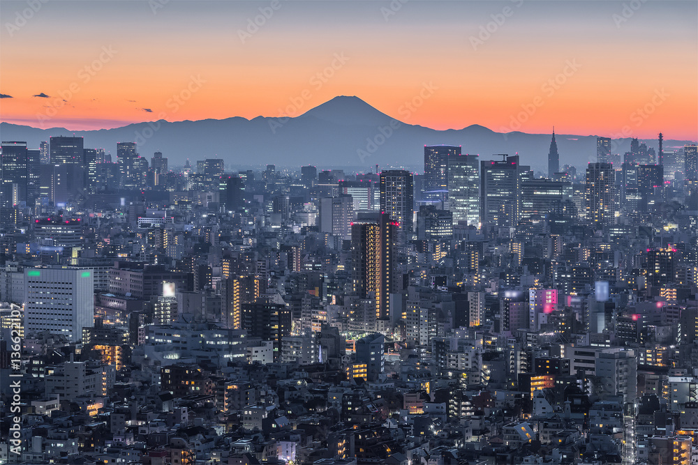 Tokyo night city view with Mountain Fuji. Mount Fuji lies about 100 kilometres south-west of Tokyo, 