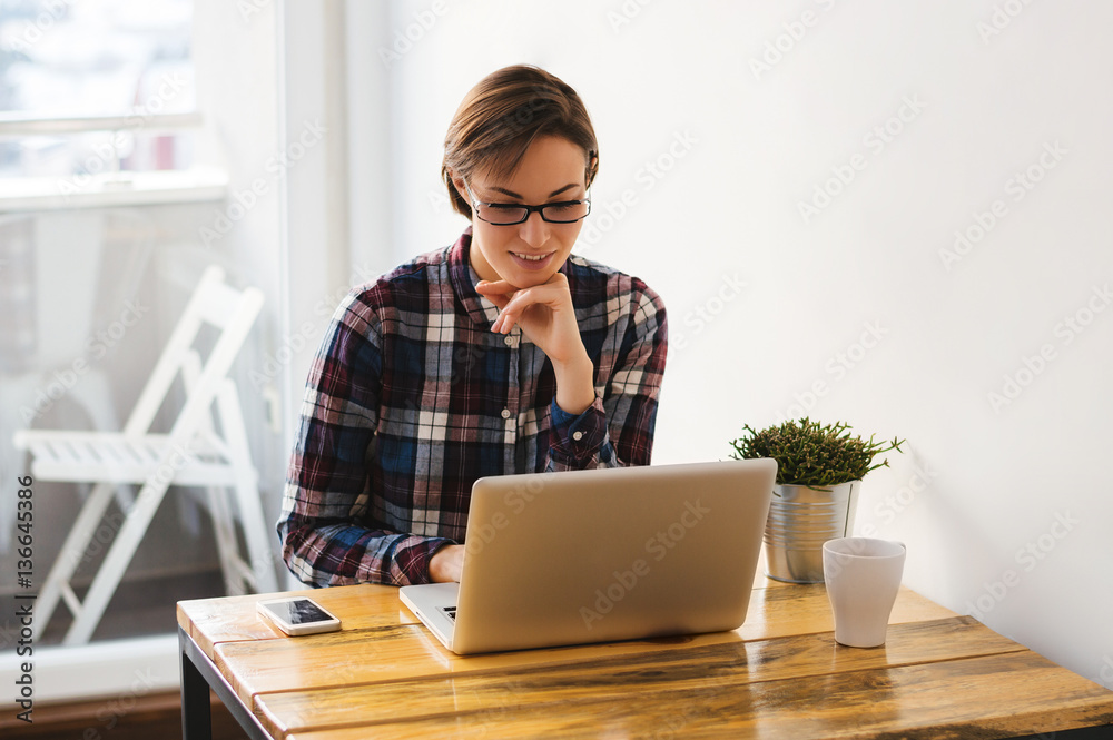 Young beautiful girl with a laptop at home