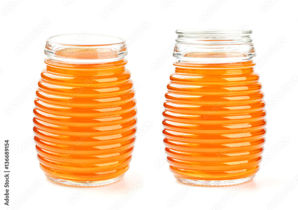 Honey in glass jar isolated on white background