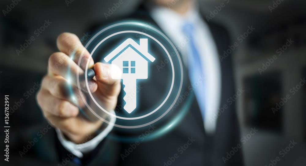 Businessman holding 3D rendering icon house in his hand