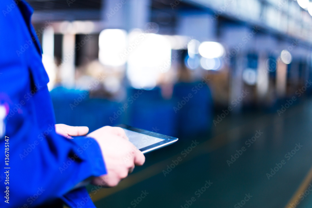 hand holds tablet in factory