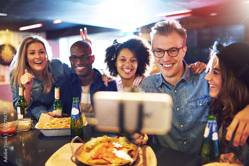 People in bar doing selfie and smiling