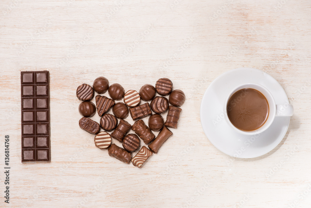 Valentine background with chocolate truffles and coffee cup.