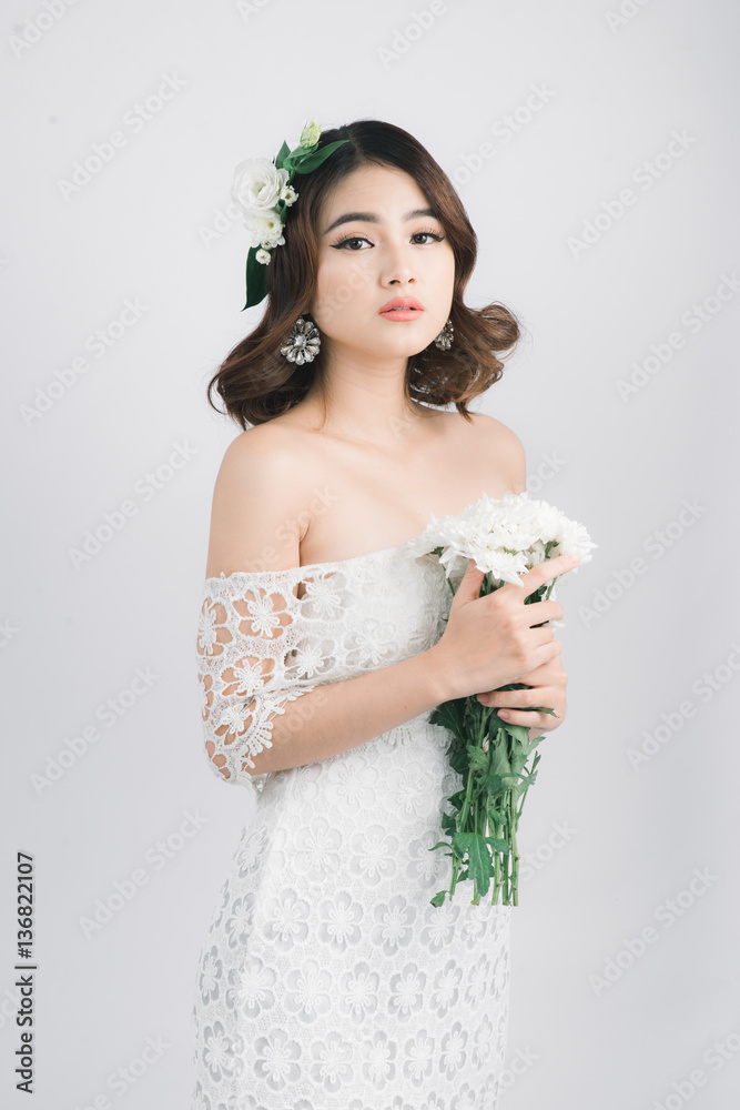 Beautiful asian woman bride on grey background.