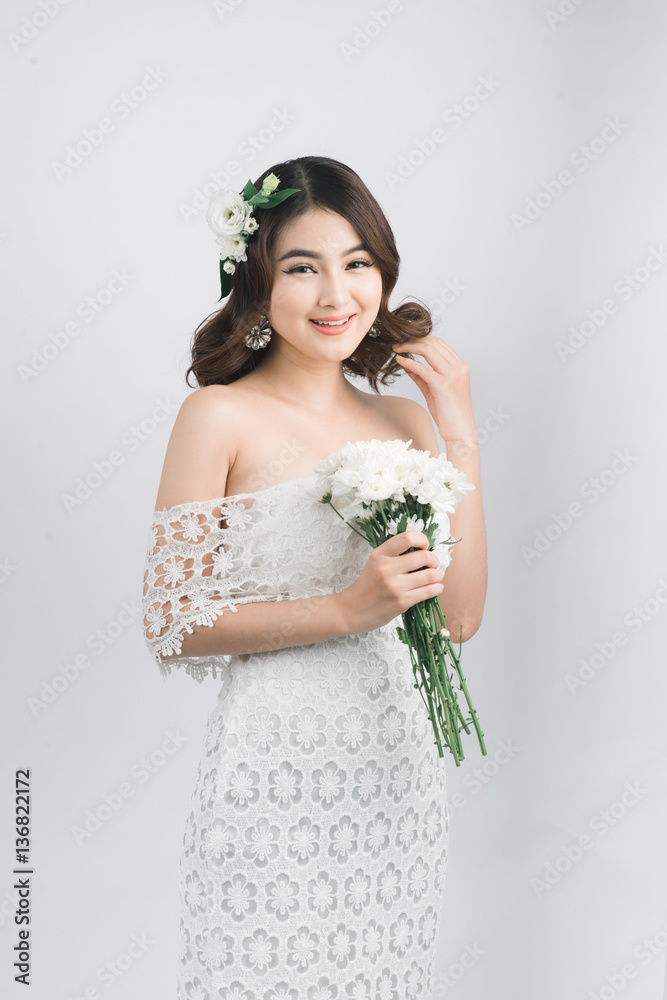 Beautiful asian woman bride on grey background.