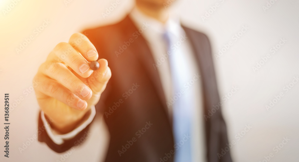 Businessman writing with a pen on a digital screen