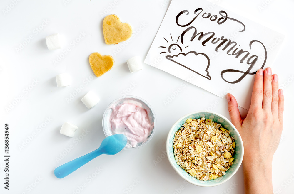 concept kid breakfast with yogurt top view white background