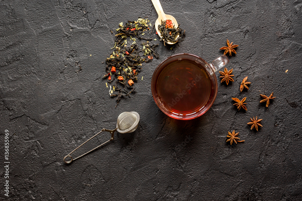 Cup of tea on black background top view