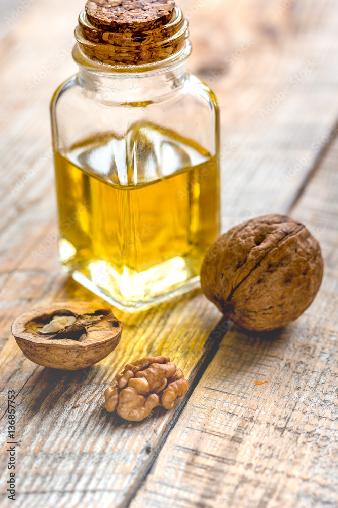 cosmetic and therapeutic walnut oil on wooden background